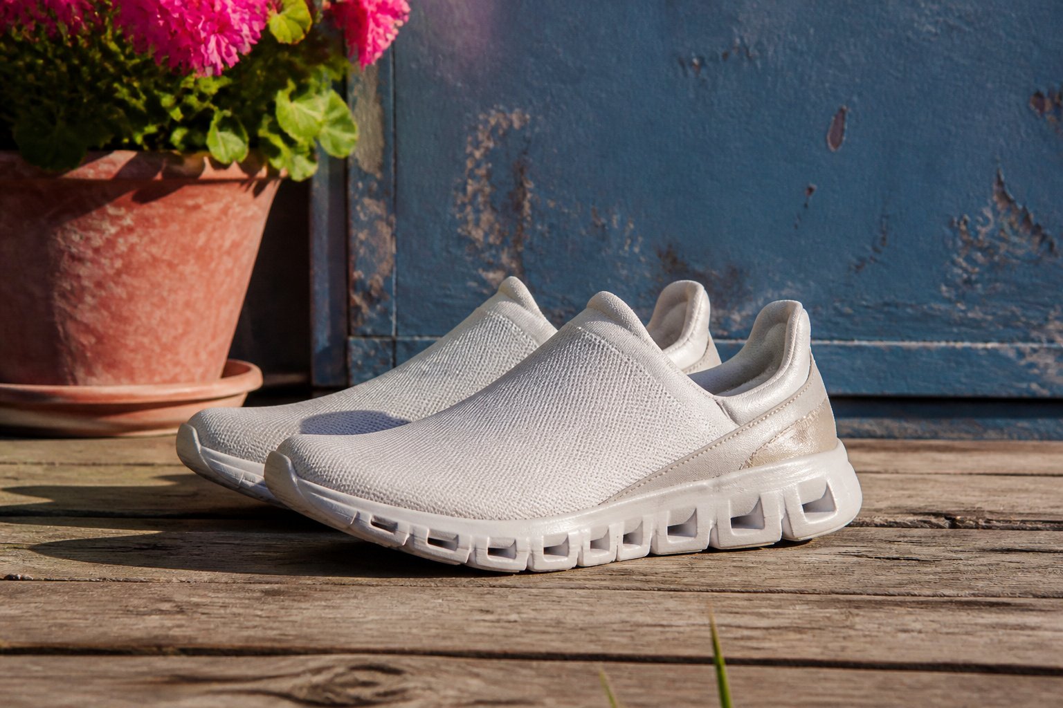 A variety of On Cloud slip-on shoes displayed on a neutral background.